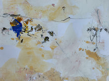 Detail of the minimal abstract painting with textured cream, beige, and light brown washes, scattered paint splatters, and a small expressive blue and gold brushstroke cluster on the right side.