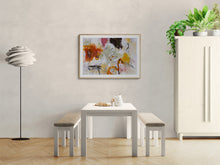 Dining room with a white table and benches, the abstract art on the wall, and a lamp.