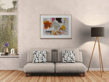 Living room with a gray sofa, the abstract art, and a lamp.