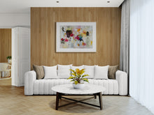 Modern living room with a white sofa, coffee table, and the painting on the wall.