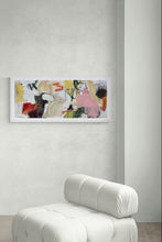 the painting on a wall above a white chair