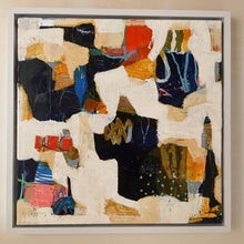 Abstract art piece with various colors and textures in a frame on the studio floor