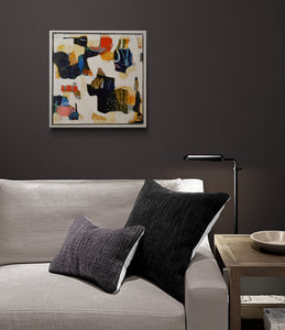 the painting in an interior with a gray sofa with dark pillows in a room with a dark wall